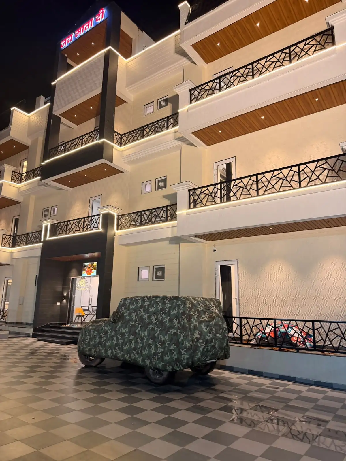Lit balconies seen from the hotel courtyard at night