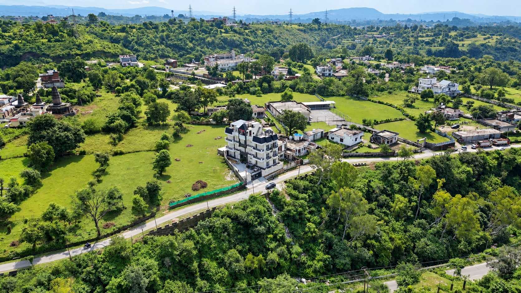 Aerial view of Hotel Ravira Krown Hills among green hills