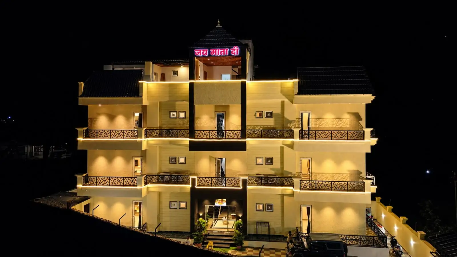 Hotel Ravira Krown Hills lit up at night